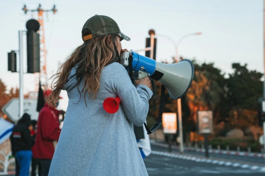 Decorative photo of protester holding microphone