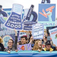 Decorative photo of people with signs boasting slogans