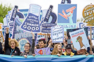 Decorative photo of people with signs boasting slogans