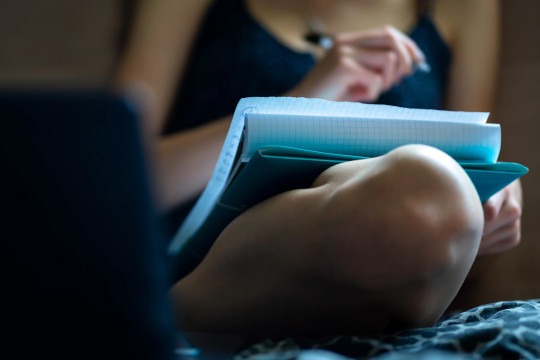 decorative photo of person holding notepad