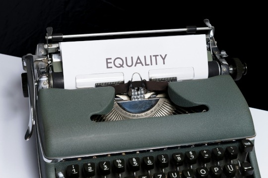 decorative photo of typewriter displaying a sheet of paper with the word "equality" typed out