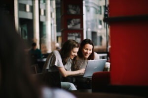 Decorative photo of two people working at laptop
