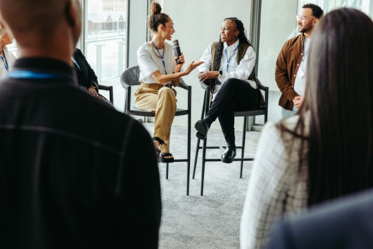 Group of professionals engaging in a business panel discussion