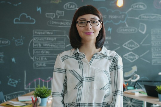decorative photo of professor in front of blackboard