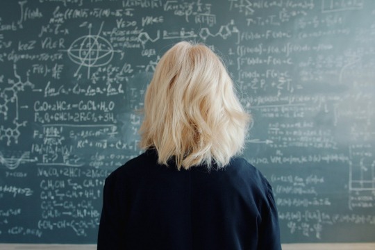 Decorative photo of person in front of blackboard