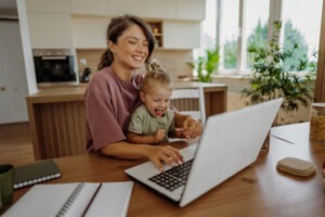 Parent and kid working together on the laptop