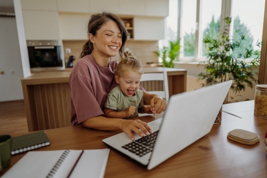 Mother and daughter working together on the laptop