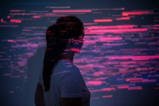 Decorative photo of person in front of light installation